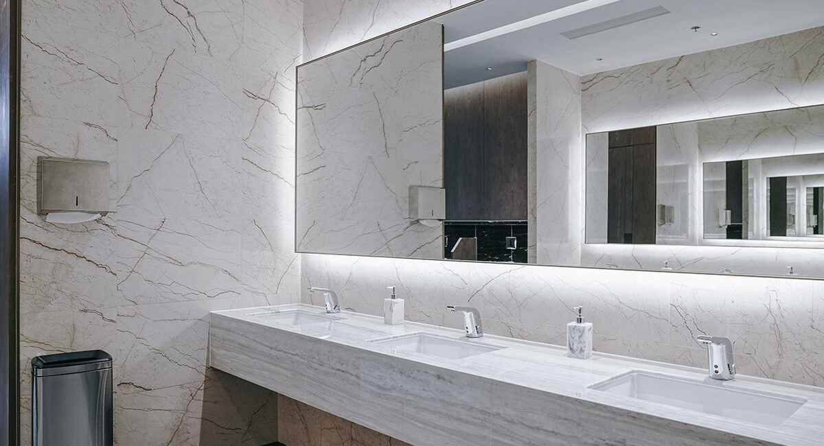 This is a photo of the marble finish on the sink and vanity units in a luxurious commercial men's bathroom installed and designed by Renovahouse in North Sydney